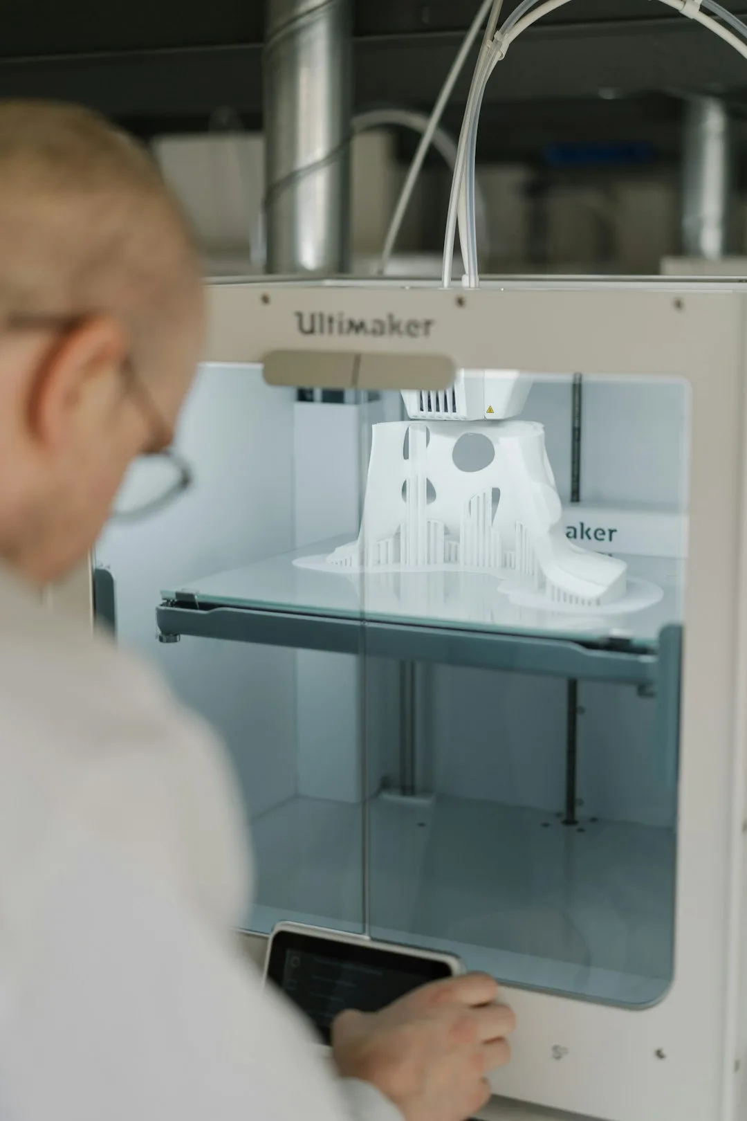 person-in-white-shirt-using-sewing-machine-qxpmfqxfzqg